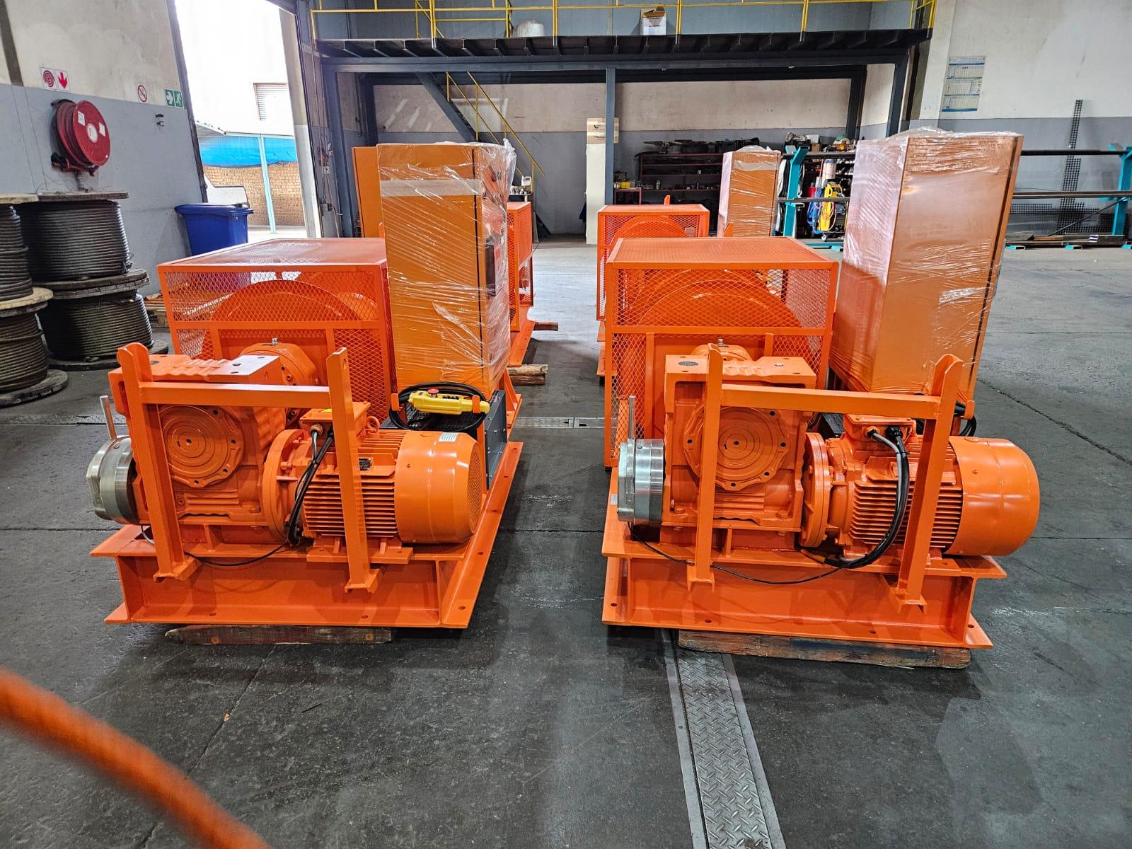 Two Winches SA custom electric drum winches with mesh safety guards and gearboxes, built for the Kusile Power Station chimney repair project